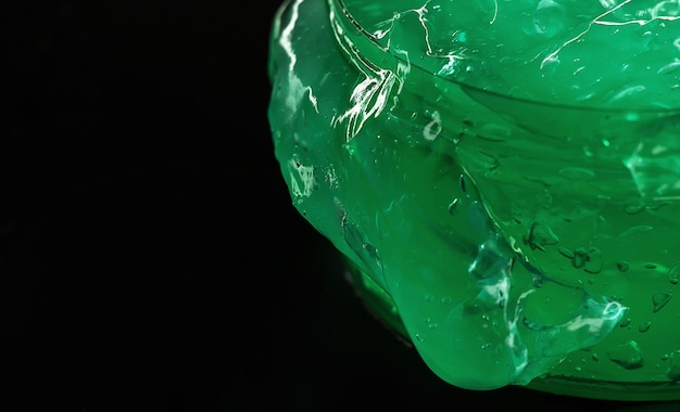 Green aloe gel on dark background