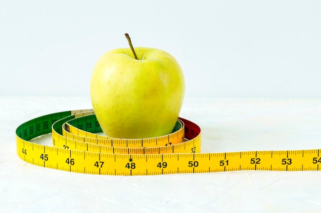 Green apple and meter on a light background