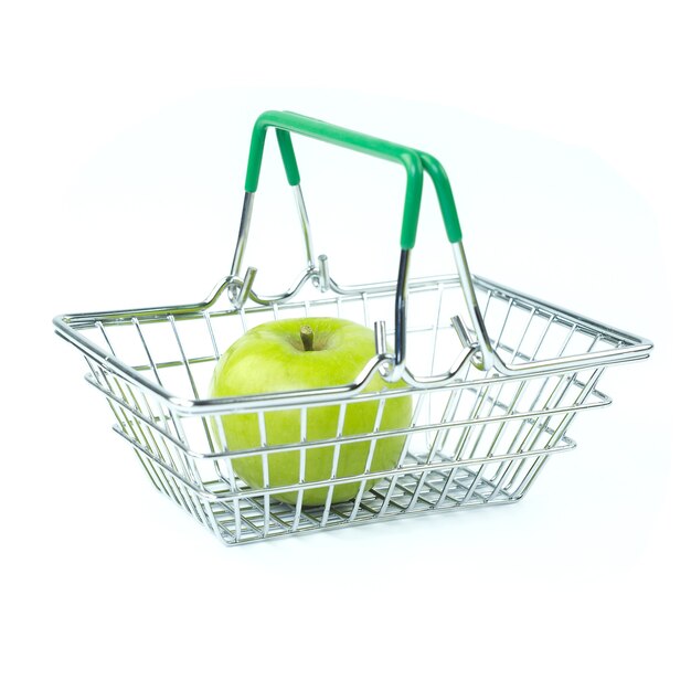 Green apple in supermarket basket