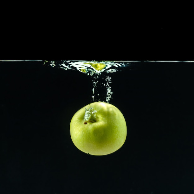 Green apple under water