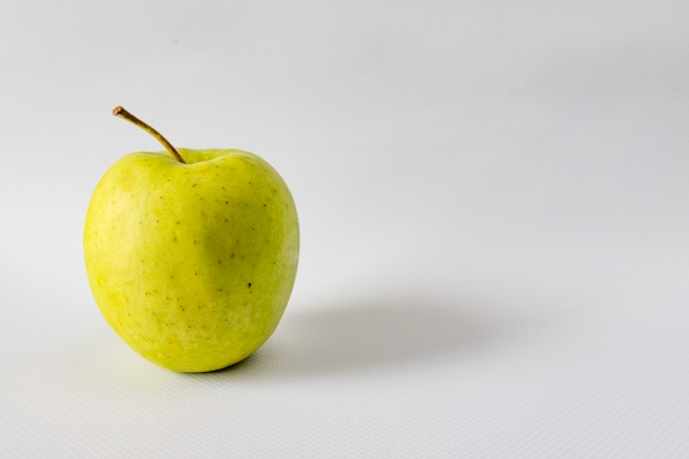 Green apple on a white background, place for text.