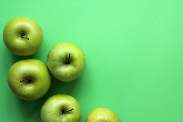 Green apples on a green background