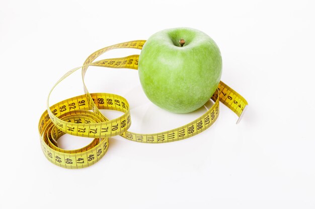 Green apples measured the meter on white background sports apples