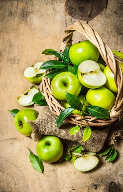 Green apples in an old basket