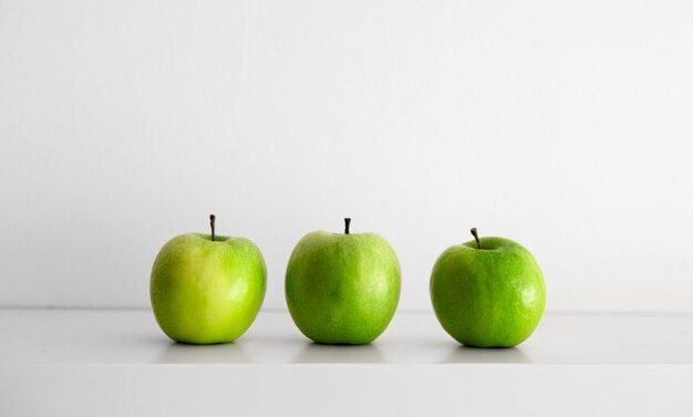 Green apples on a white background closeup