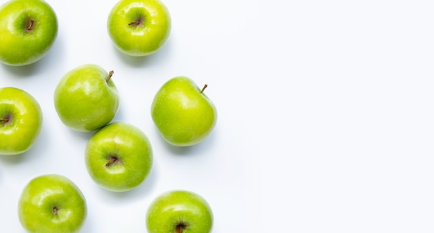 Green apples on white . Copy space