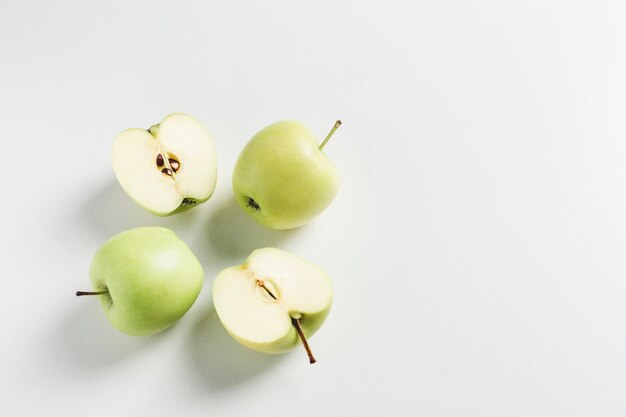 Green apples on white table