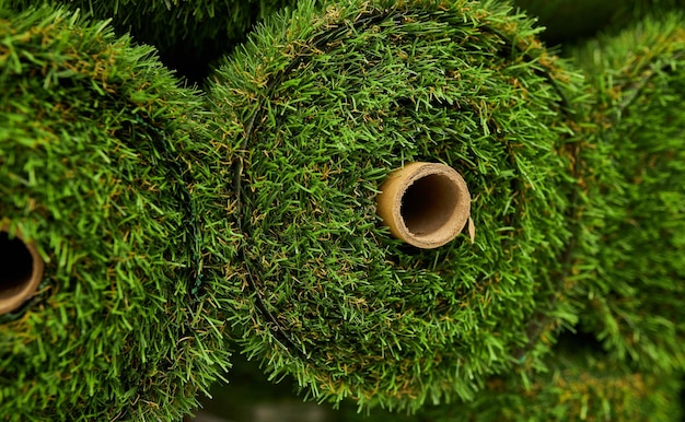 green artificial grass in rolls close up Rolls artificial grass in store of building materials