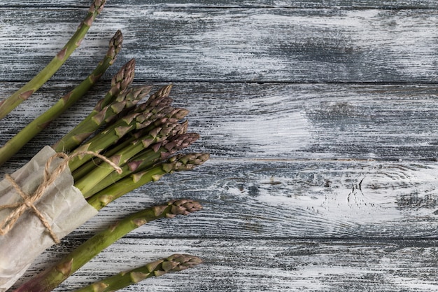 Green Asparagus. Bunches of green asparagus on a blue wooden rustic background