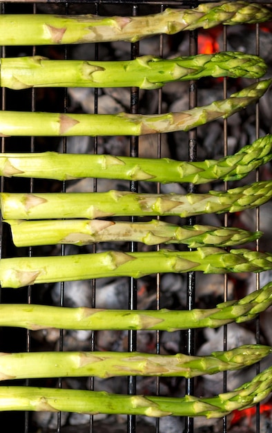 Green asparagus cooking and steaming on grill platexAGRILLED ASPARAGUSxA