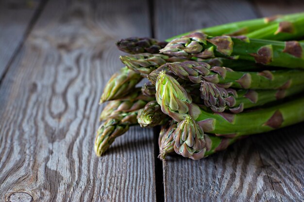 Green asparagus on a dark wooden background