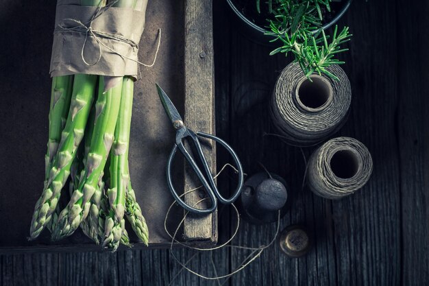 Green asparagus and fresh rosemary on rustic table