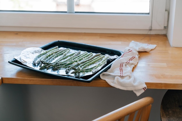 Green Asparagus sprouts on frying pen in kitchen Grilled fresh vegetables