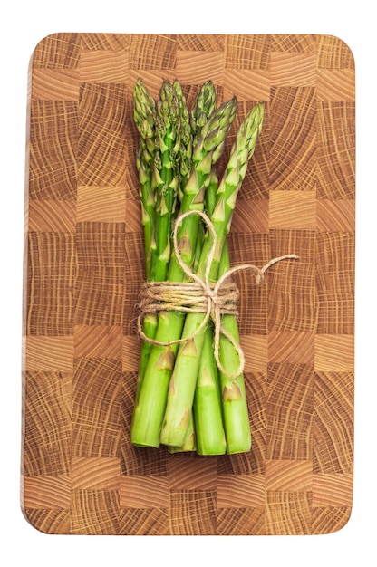 green asparagus tied with a rope on a wooden board