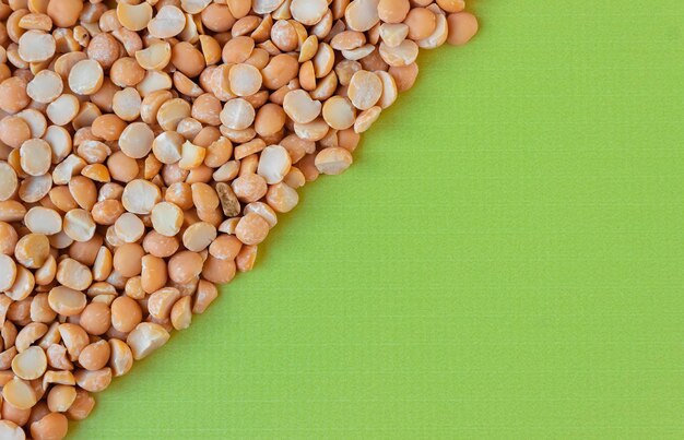 Green background of dry pea grains. Top view, copy space.