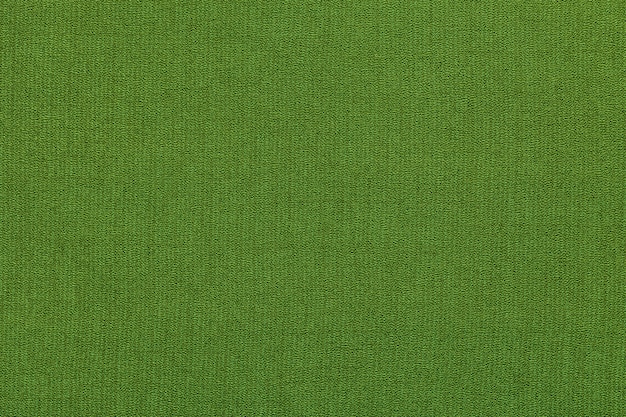 Photo green background from a textile material with pattern, closeup. structure of the fabric with natural texture.