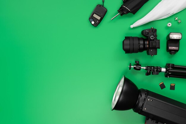 Green background table with some photography objects and accessories Horizontal composition with copy space on the left