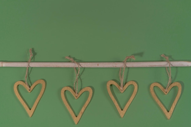 Green background with rustic branch and hearts