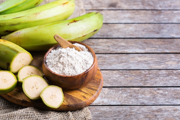 Green banana, plantains flour on a table. Copy space background