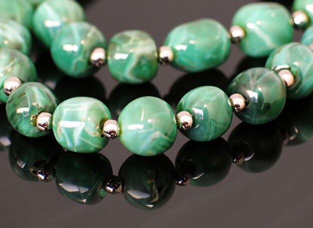 Photo a green bead necklace with a silvertone finish.