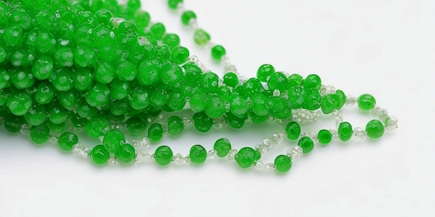 Green beads on a white background Small beads on a white background for weaving Material for handm