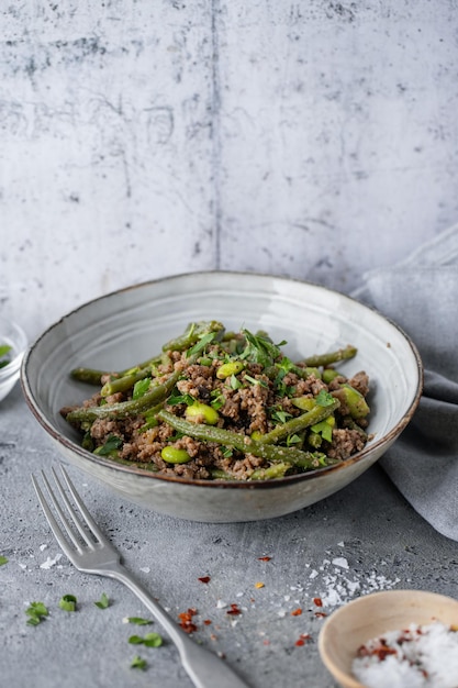 Green beans with minced meat in bowl