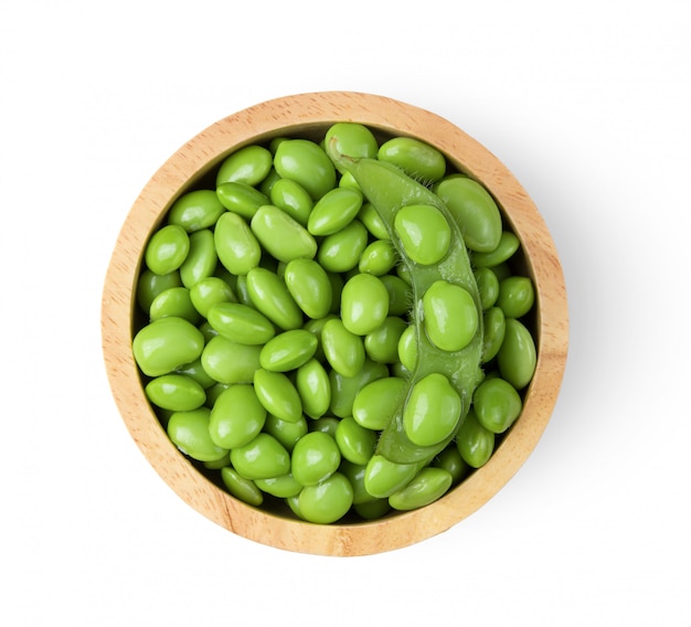 Green beans in wood bowl isolated on white background top view.