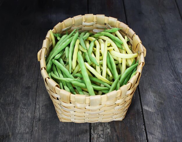 Green beans on wooden surface Close up top view