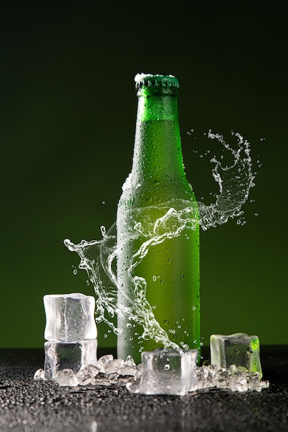 Green beer bottle with splash