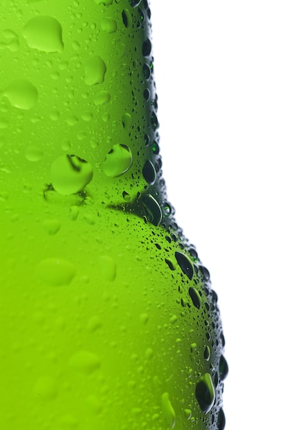 Green beer bottle with water drops isolated on white