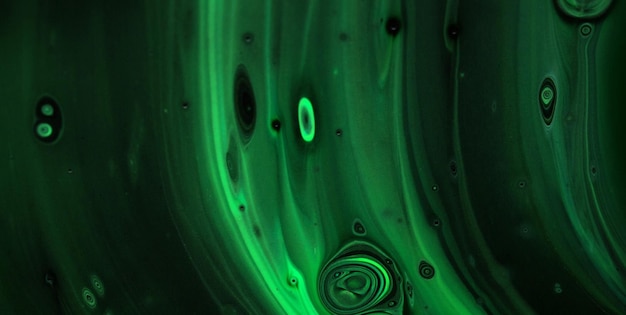 Green and black background with a drop of water in the center