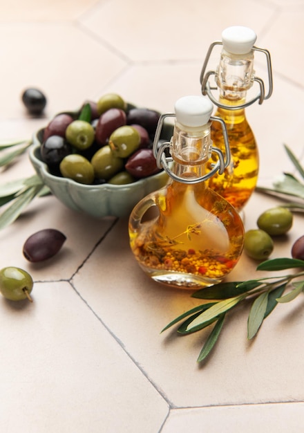 Green and black olives with olive oil on tiled kitchen counter