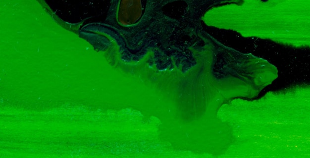 a green and black speckled surface with a green background