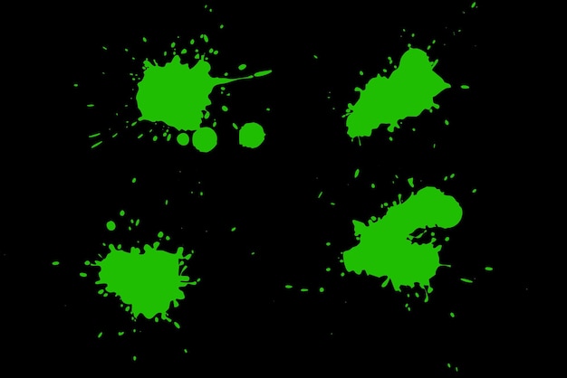 Green blot on a black background Spots of paint on a piece of paper