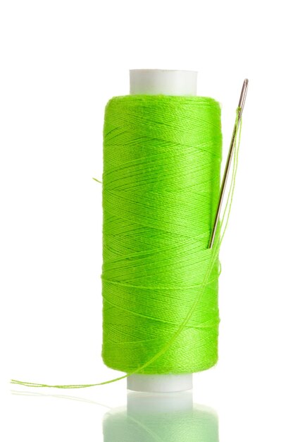 Green bobbin with needle isolated on white