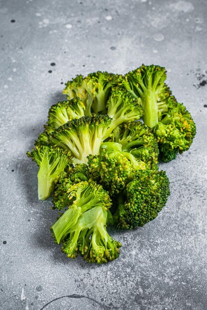 Green boiled broccoli cabbage on kitchen table. Gray background. Top view.