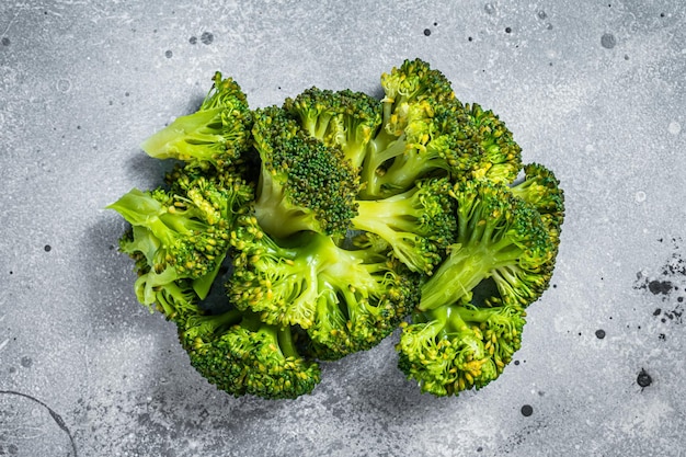 Green boiled broccoli cabbage on kitchen table. Gray background. Top view.