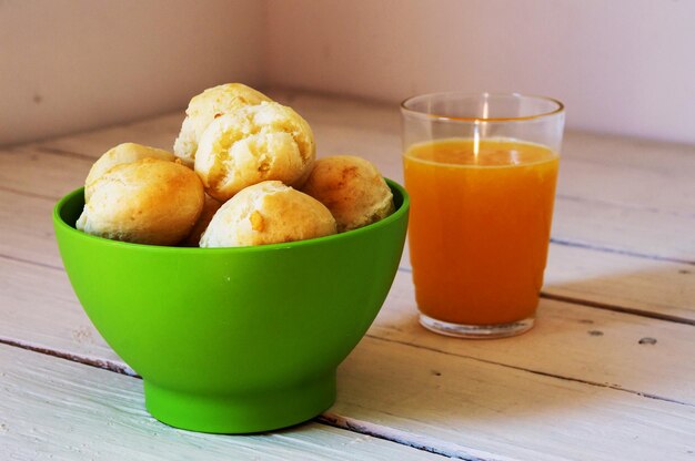 Green bowl full of cheese rolls