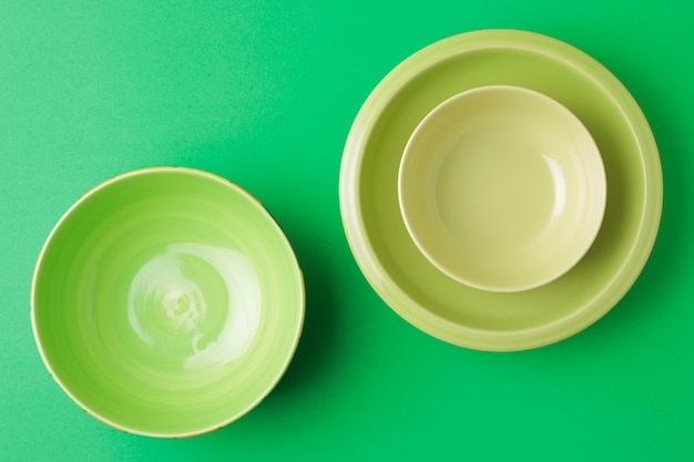 green bowl and plate on green table.