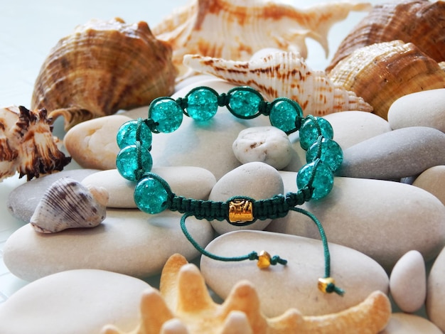 Green bracelet and sea shells