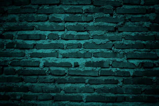 A green brick wall with a blue background.