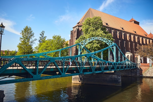 Green Bridge adorned with many love locks and hearts, in Wroclaw