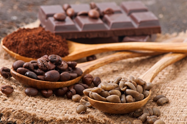 Green and brown coffee beans in bowls