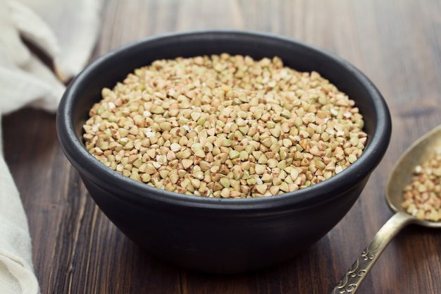 Green buckwheat in black bowl