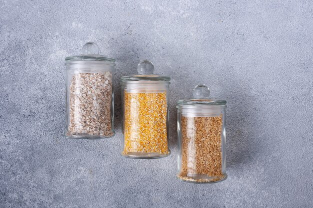 Green buckwheat corn millet groats in glass jars