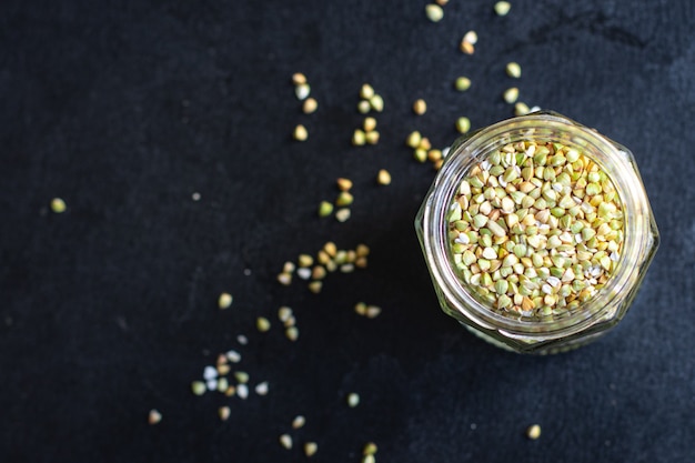 green buckwheat raw grain on the table wholesome food healthy food