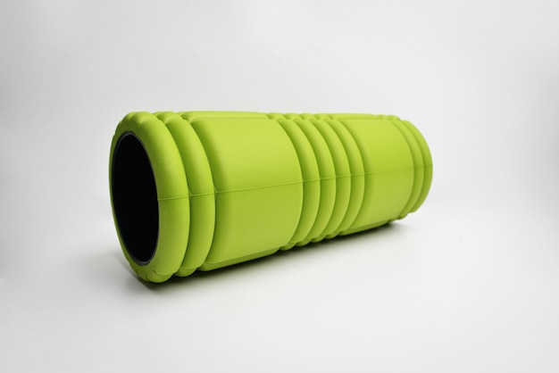 A green bumpy foam massage roller