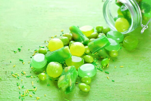 Photo green candies scattered on table