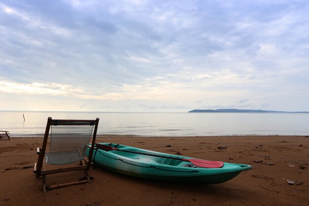 Green canoes and beach seats, one of the beaches in Koh Krut, Thailand