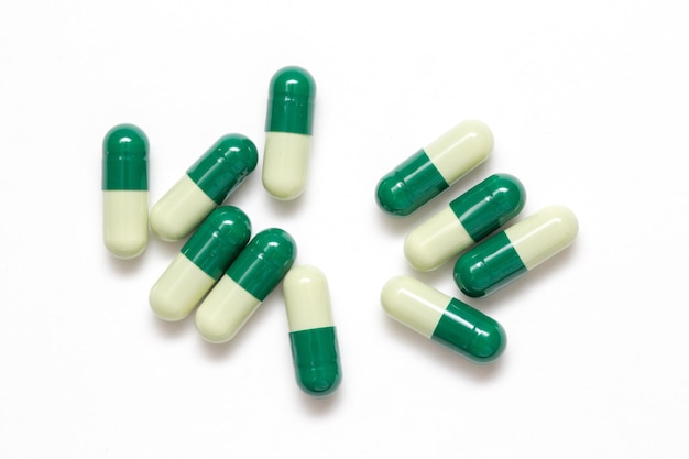 Green capsules closeup isolated on white background